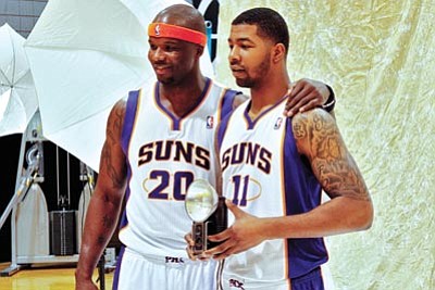 Matt York/The Associated Press<br>
The Suns’ Markieff Morris (11) and Jermaine O’Neal  pose with a vintage camera during the NBA media day Monday in Phoenix.
