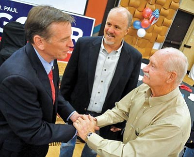 Matt Hinshaw/The Daily Courier<br /><br /><!-- 1upcrlf2 -->Al Brown, right, and Dave Barrett congratulate Congressman Paul Gosar Tuesday night during the Yavapai County GOP election night party at the Prescott Resort.