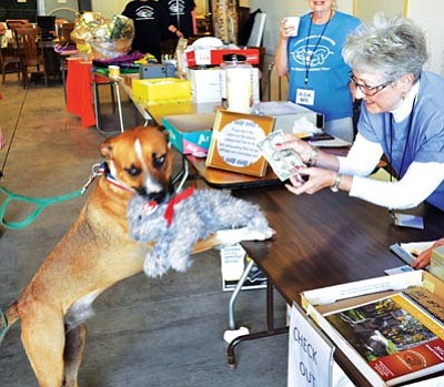 Courtesy photo<br>Jane Meyers assists Henry with his purchase at last year’s United Animal Friends rummage sale. This year’s event is 10 a.m. to 5 p.m. Nov. 9-14 at Prescott Gateway Mall in the Sears wing.