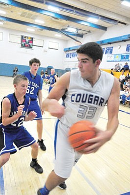 Matt Santos/Courtesy<br>Cole Padilla scrambles for a loose ball in the final quarter of Tuesday night’s 53-30 loss to the Cowboys. Padilla ended the night with 20 points.