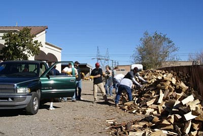 Courtesy photo<br>Arizona Public Services donates a truckload of wood that its forestry crews chopped from trees it felled because they were in the way of power lines in 2008.