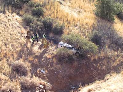 Courtesy photo Prescott Valley Police Department<br>
Rescue workers arrive Sunday at the scene of a single-vehicle accident that killed Frank Heischman, 60, of Prescott Valley off Highway 69 east of Mendecino Drive.