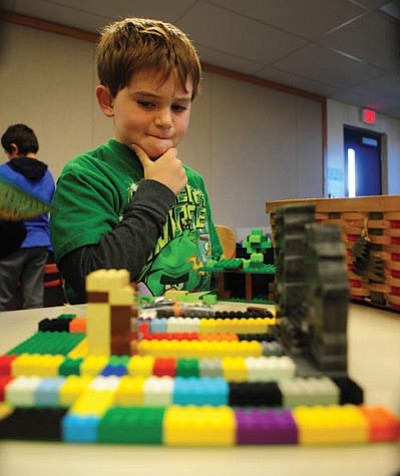 Les Stukenberg/The Daily Courier<br>Third grader Ethan Lowe considers what to add to the tree house he is building at the Miller Valley School after school Lego club that is funded by donated tax credit money.
