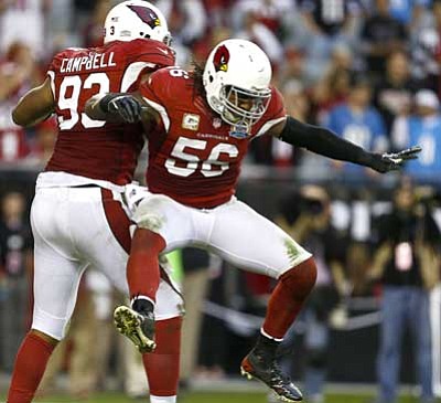 Ross D. Franklin/The Associated Press<br>
Arizona Cardinals' Reggie Walker (56) and Calais Campbell (93) celebrate a sack against the Detroit Lions Matthew Stafford during the second half in an NFL football game on Sunday in Glendale. The Cardinals defeated the Lions 38-10.