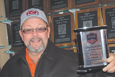 Ken Hedler/The Daily Courier<br>Don Fishel, Prescott’s recreation supervisor and Arizona state commissioner for the Amateur Softball Association of America, in this photo from January of 2011 displays the James Farrell ASA Award of Excellence in 2010 for hosting three national tournaments.
