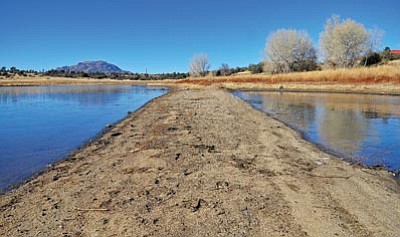 Matt Hinshaw/The Daily Courier<br>A long sandbar juts off the north shore of Willow Lake in Prescott, Wednesday afternoon after the lake level declined significantly in 2012.