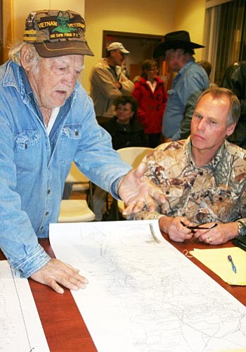 Sue Tone/Courtesy photo<br /><br /><!-- 1upcrlf2 -->Charlie Freeman, left, talks with Owen Wildman over a mining map after a meeting about setting up a mining district in the Bradshaw Mountains.<br /><br /><!-- 1upcrlf2 -->