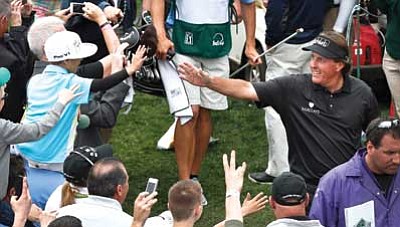 Ross D. Franklin/The Associated Press<br>
After the final round, Phil Mickelson, upper right, celebrates with the crowd after winning the Waste Management Phoenix Open on Sunday in Scottsdale.