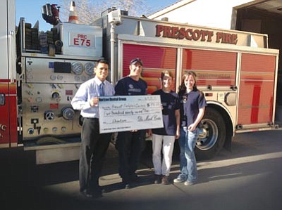 Courtesy photo<br /><br /><!-- 1upcrlf2 -->Dr. Mark Costes, left, of Horizon Dental Group presents Travis McElwee and Erin Bennett of Prescott Firefighters’ Charities with a check for $596.23 Monday outside Prescott Fire Station 75 on Lee Boulevard while Billie Denike, chairwoman of Prescott Firefighters Charities, looks on looks on.