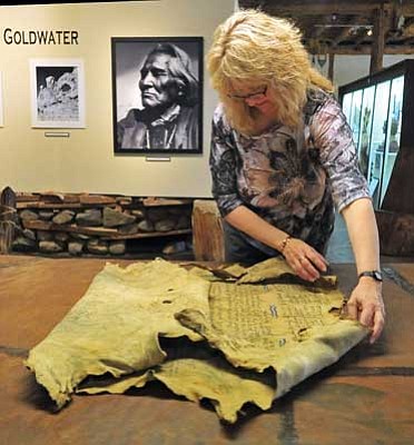 Matt Hinshaw/The Daily Courier<br>
Cindy Gresser, executive director of the Smoki Museum, carefully rolls out the 1925 Calvin Coolidge buckskin Wednesday afternoon in Prescott. 

