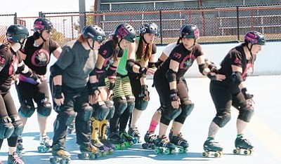 Patrick Whitehurst/The Daily Courier<br>
Members of the Whiskey Row-llers, part of the Northern Arizona Roller Derby League, skate in unison at Pioneer Park Roller Rink on Sunday. The league conducted a boot camp March 17 open to women who are both new and familiar to the sport.