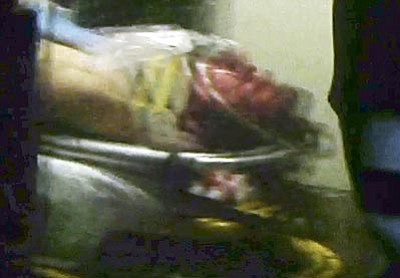 Robert Ray/The Associated Press<br>
This still frame from video shows Boston Marathon bombing suspect Dzhokhar Tsarnaev visible through an ambulance after he was captured in Watertown, Mass., Friday. 

