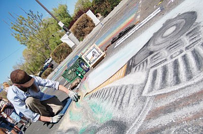 Patrick Whitehurst/
The Daily Courier<br>
Prescott artist Jeff Daverman works on a chalk piece titled “The Train,” dedicated to his grandfather, who worked as a chalk artist for 60 years.