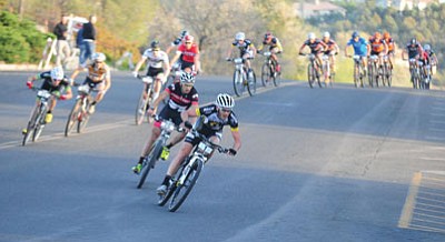 Les Stukenberg/The Daily Courier<br>Last year’s champion Geoff Kabush leads the field down Goodwin Street during the Whiskey Off-Road Fat Tire Crit through the streets of downtown Prescott Friday evening.