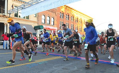 Matt Hinshaw/The Daily Courier<br>Last year's runners burst from the starting line to kick of the 2012 Whiskey Row Marathon.