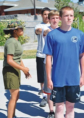 Alfonso Santillan/Courtesy photo<br>Ashley Santillan, left, a graduate of Devil Pup Class of 2011, pre-trains teenagers 14 to 17 years old on Saturdays at Prescott High School for the Devil Pups program in July at the U.S. Marine Corps base in Camp Pendleton, Calif.
