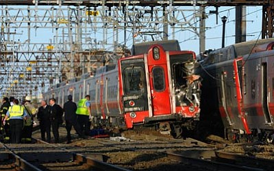 Christian Abraham/The Associated Press<br>
Emergency workers arrive at the scene of a train collision Friday in Fairfield, Conn.
