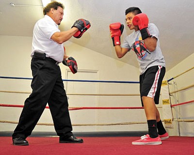 Matt Hinshaw/The Daily Courier<br>Prescott boxer Alejandro Larrondo, right, under the guidance of veteran coach Jake Magallanez has a chance this month to qualify for nationals.