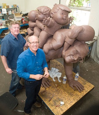 Les Stukenberg/The Daily Courier<br>Jeff and Glenn Keane work on the clay model of a sculpture honoring their father, Family Circus cartoonist Bill Keane, at Bronzesmith in Prescott Valley Thursday.