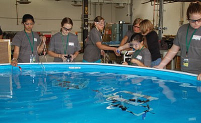Lisa Irish/The Daily Courier<br>
Bradyn Braithwaite, left, watches as his partner Dallan Bertoch pilots their remote-operated vehicle during Yavapai College’s free summer robotics camp Friday.