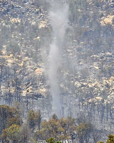 Matt Hinshaw/The Daily Courier<br>
A funnel cloud moves through an area at the base of Granite Mountain that was scorched by the Doce Wildfire Thursday morning west of Prescott.