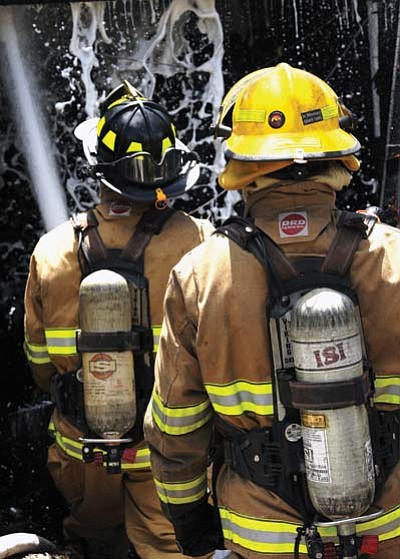 Wade Ward, Prescott Fire Department/Courtesy photo<br>
Firefighters from the Prescott Fire Department battle a fire in a large work shed on Granite Street. Crews responded to the fire just after 12:30 p.m. Monday. A house on the property was saved, according to fire personnel.

