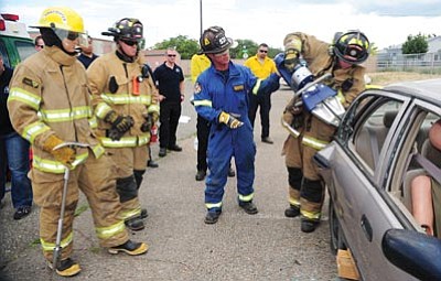 Les Stukenberg/The Daily Courier<br>Instructor Jamie Ingaro shows students the best way to use a Hurst tool during the extrication portion of the Yavapai College paramedic program at its Prescott Valley campus.
