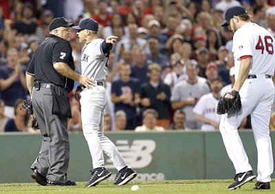 Michael Dwyer/The Associated Press<br>Yankees manager Joe Girardi, center, points at Ryan Dempster while arguing with home plate umpire Brian O'Nora after Dempster hit Alex Rodriguez Sunday night in Boston.