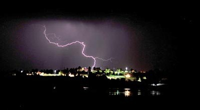 Matt Hinshaw/The Daily Courier<br>Lightning strikes over Willow Lake in Prescott Thursday night during a thunderstorm. The National Weather Service is predicting heavy rain and flooding through the weekend for Yavapai County.