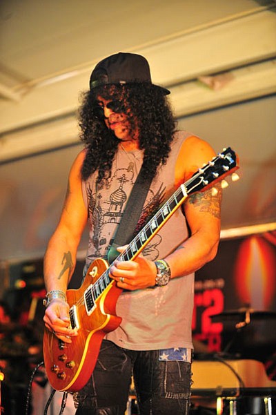 Matt Hinshaw/The Daily Courier<br>
Slash performs in the Rock N’ 2 Remember benefit for Yarnell, Sunday at the Prescott Rodeo Grounds.
