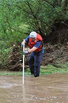 Wade Ward, Prescott Fire Department/Courtesy photo<br>
A Prescott Fire Department member searches for a body in Granite Creek Monday. Authorities are reminding people to take great care around floodwaters during this especially heavy rainy season.
