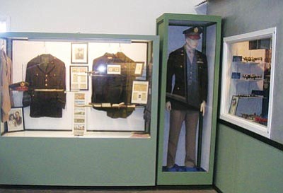 Cheryl Prill/Courtesy photo<br /><br /><!-- 1upcrlf2 -->Uniforms, ID cards and other World War II memorabilia once belonging to Prescott resident Lee Roy Gudgel are on display at the Planes of Fame Air Museum in Valle, Ariz.