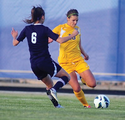 Les Stukenberg/The Daily Courier<br>ERAU’s Carissa Frazier, right, takes a shot on goal during Thursday’s match against Menlo College at Embry-Riddle in Prescott.