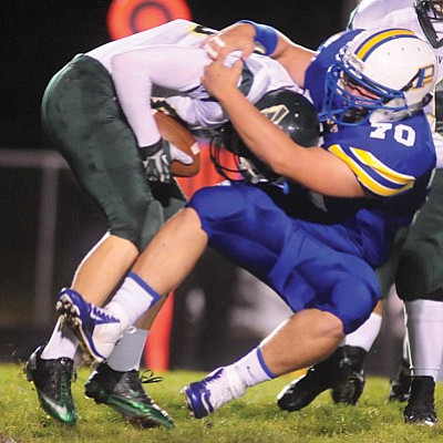 Les Stukenberg/The Daily Courier<br>Prescott’s David Rupp tackles Mohave quarterback Dawson Rickets in the backfield for a loss during the Badgers’ big 55-0 Homecoming win Friday night at Bill Shepard Field.