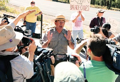 Courtesy photo<br>Grand Canyon National Park Superintendent Dave Uberuaga speaks to protesters and the media Wednesday.
