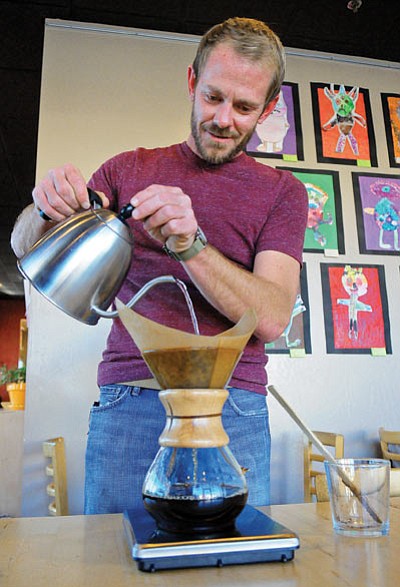 Matt Hinshaw/The Daily Courier<br>
Owner Joseph Burton pours a pot of Ethiopia Mokamba coffee using a Chemex coffee maker.    
