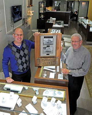 Matt Hinshaw/The Daily Courier<br>Greg Raskin, owner of Raskin’s Jewelers in downtown Prescott, and his father, Lynn, display historic photos of their Phoenix locations in 1946 and 1951. Lynn expanded to Prescott by opening the first shop here on Goodwin Street in 1963. Raskin’s current location is 110 W. Gurley St.
