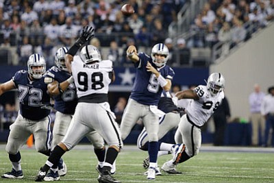 LM Otero/The Associated Press<br>Cowboys quarterback Tony Romo passes the ball against the Raiders during Thursday's second half in Arlington, Texas.