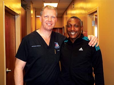 Courtesy photo<br>Bertrand Kaper, M.D., left, a Prescott orthopedic surgeon, and Pastor Greyson Badatu, pose for a photo during Badatu’s follow-up visit with the doctor after his hip replacement surgery in early December.