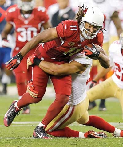Matt York/The Associated Press<br>
Arizona Cardinals wide receiver Larry Fitzgerald makes a catch against the San Francisco 49ers on Sunday in Glendale.