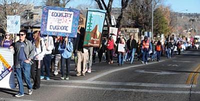 Les Stukenberg/The Daily Courier<br>
Nearly 300 people march to honor Dr. Martin Luther King through the streets of downtown Prescott Monday morning. Most of the marchers then turned to doing service projects around the tri-city area.