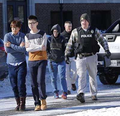 Journal & Courier, John Terhune/The Associated Press<br>
Police evacuate students from the Electrical Engineering building after shots were fired on Tuesday on the campus of Purdue University in West Lafayette, Ind.