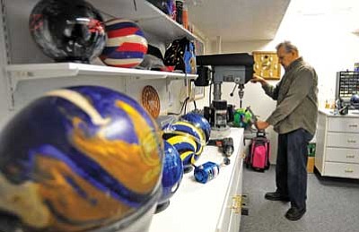 Matt Hinshaw/The Daily Courier<br>
Jerry Dallum drills holes in a customer’s bowling ball Wednesday afternoon at his home workshop in Prescott. Dallum has been working on and repairing bowling balls for the past 26 years.