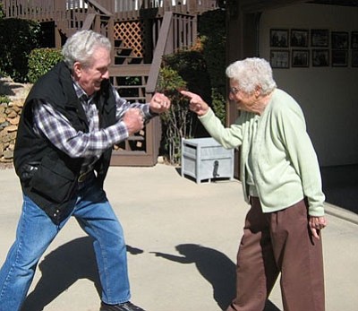 Courtesy photo<br> 
Frank Finley and Joan Bigley face-off against each other in front of Joan’s home.