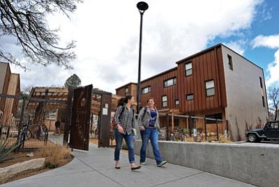 Matt Hinshaw/The Daily Courier<br>Freshmen Martha Campbell and Carmen Francesco walk out of the Prescott College residence hall on their way to class Thursday afternoon.