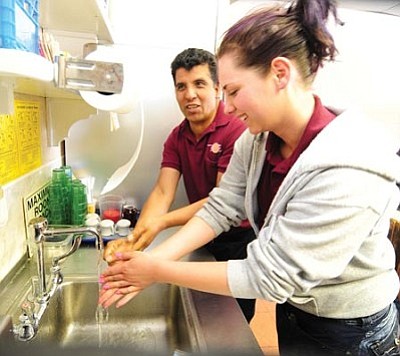 Les Stukenberg/The Daily Courier<br>Taylor Horn and Ramiro Gomez wash their hands at the servers’ sink at Jaime’s Waffle Express in Prescott Valley. The restaurant recently won a Golden Plate award from the Yavapai County Health Department.