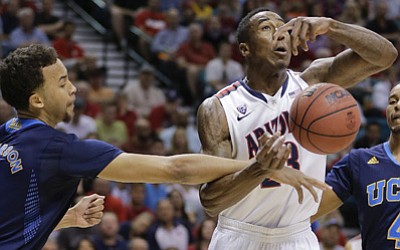 Julie Jacobson/The Associated Press<br>
Arizona’s Rondae Hollis-Jefferson, right, is fouled by UCLA’s Kyle Anderson in the first half during the championship game of the NCAA Pac-12 conference college basketball tournament, Saturday in Las Vegas. 
