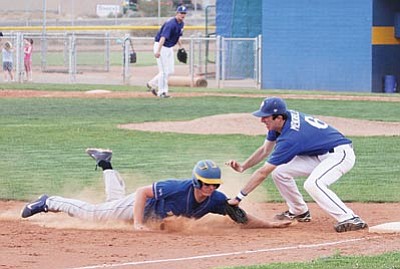 JC Amberlyn/Kingman Daily Miner, Courtesy<br>Kingman’s Tyler Logas, left, dives into the third base bag and gets tagged out by Prescott’s Matthew Mendibles Friday afternoon in Kingman.