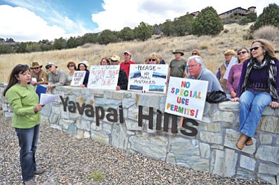 Matt Hinshaw/The Daily Courier<br>
Wendy Ratner reads a letter to fellow protesters demonstrating Saturday against the height of the Touchmark at the Ranch Development, near Lee Blvd and Yavapai Drive. Neighbors of the proposed project are leery of the building height, as well as potential traffic congestion.