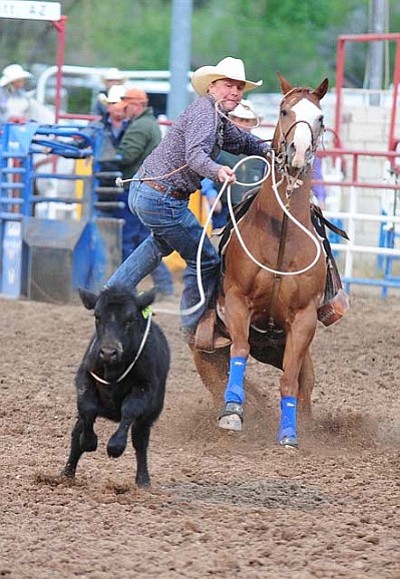 Les Stukenberg/The Daily Courier<br>Wyatt Althoff steps off his horse during the match tie down roping at the Chuck Sheppard Memorial Roping back on May 10, 2013, at the Prescott Rodeo Grounds.